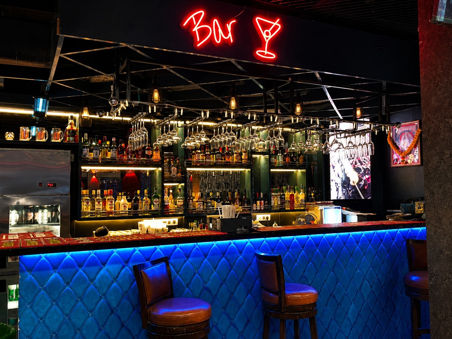 Artfully plated signature cocktail with garnish being prepared behind the bar counter at Big Bull Cafe Mumbai